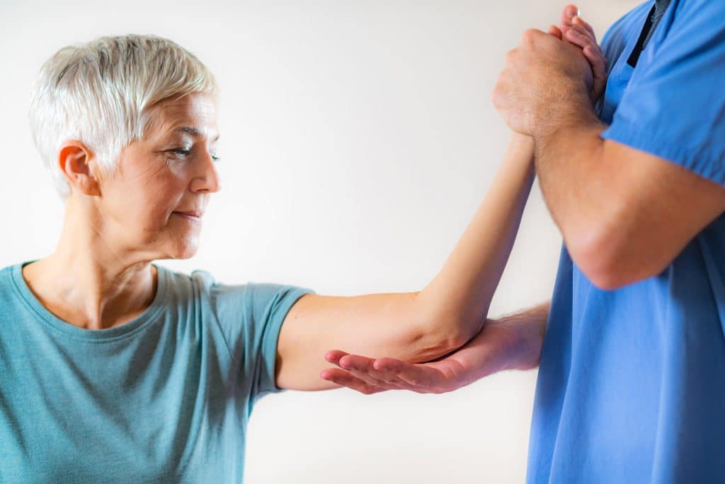 Older adult receiving assisted arm movement during physiotherapy for arthritis in Calgary