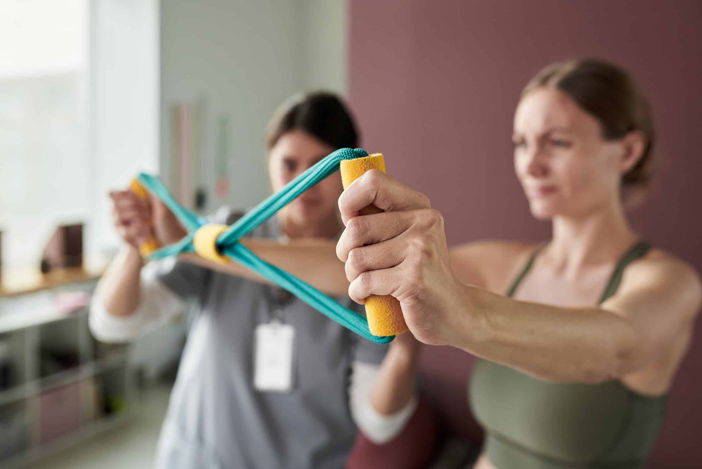 Patient using resistance bands under therapist guidance during physiotherapy for arthritis in Calgary